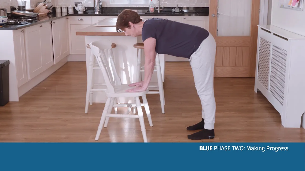 a woman bending over a chair