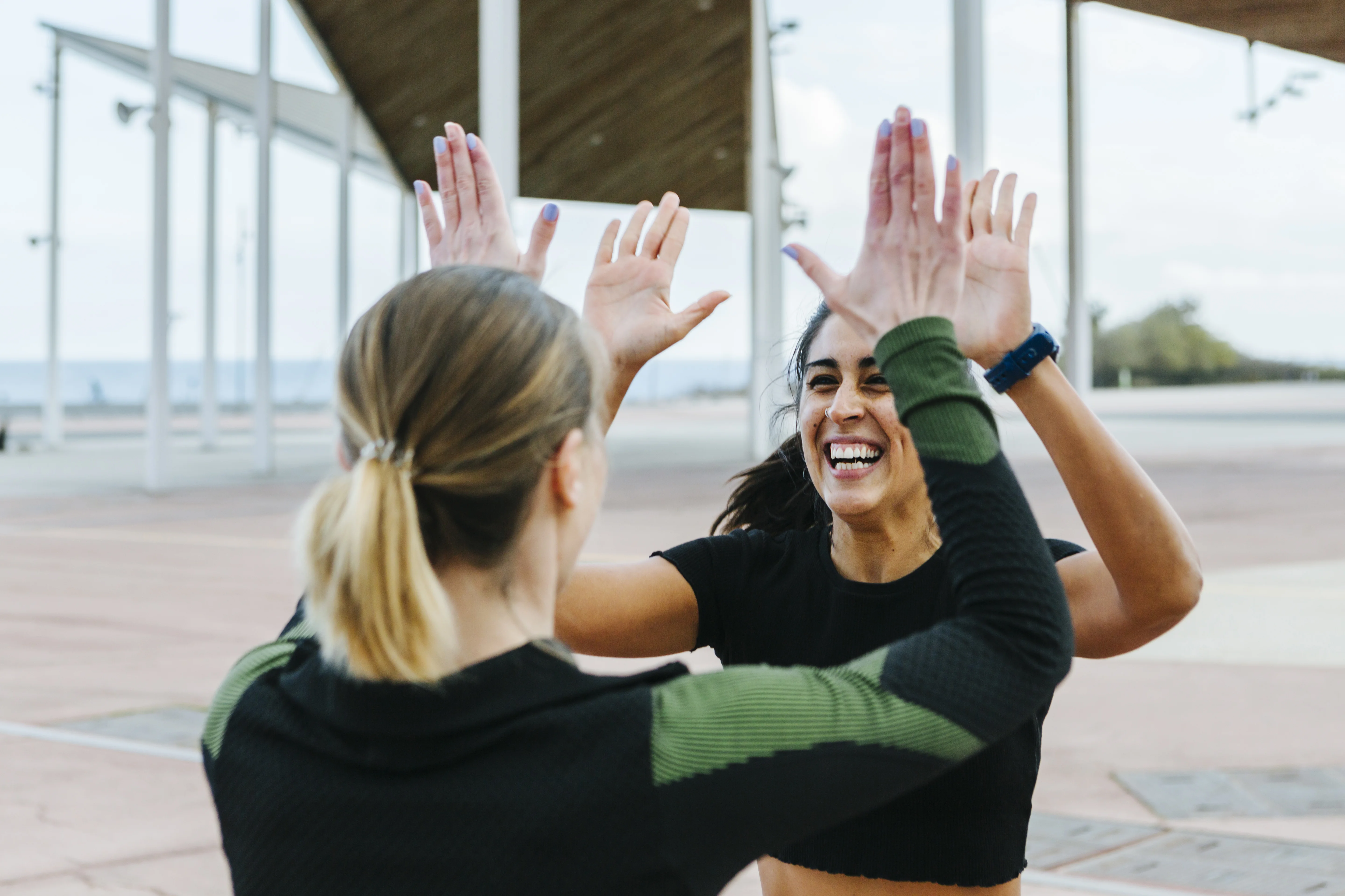 Two women giving each other high five. 