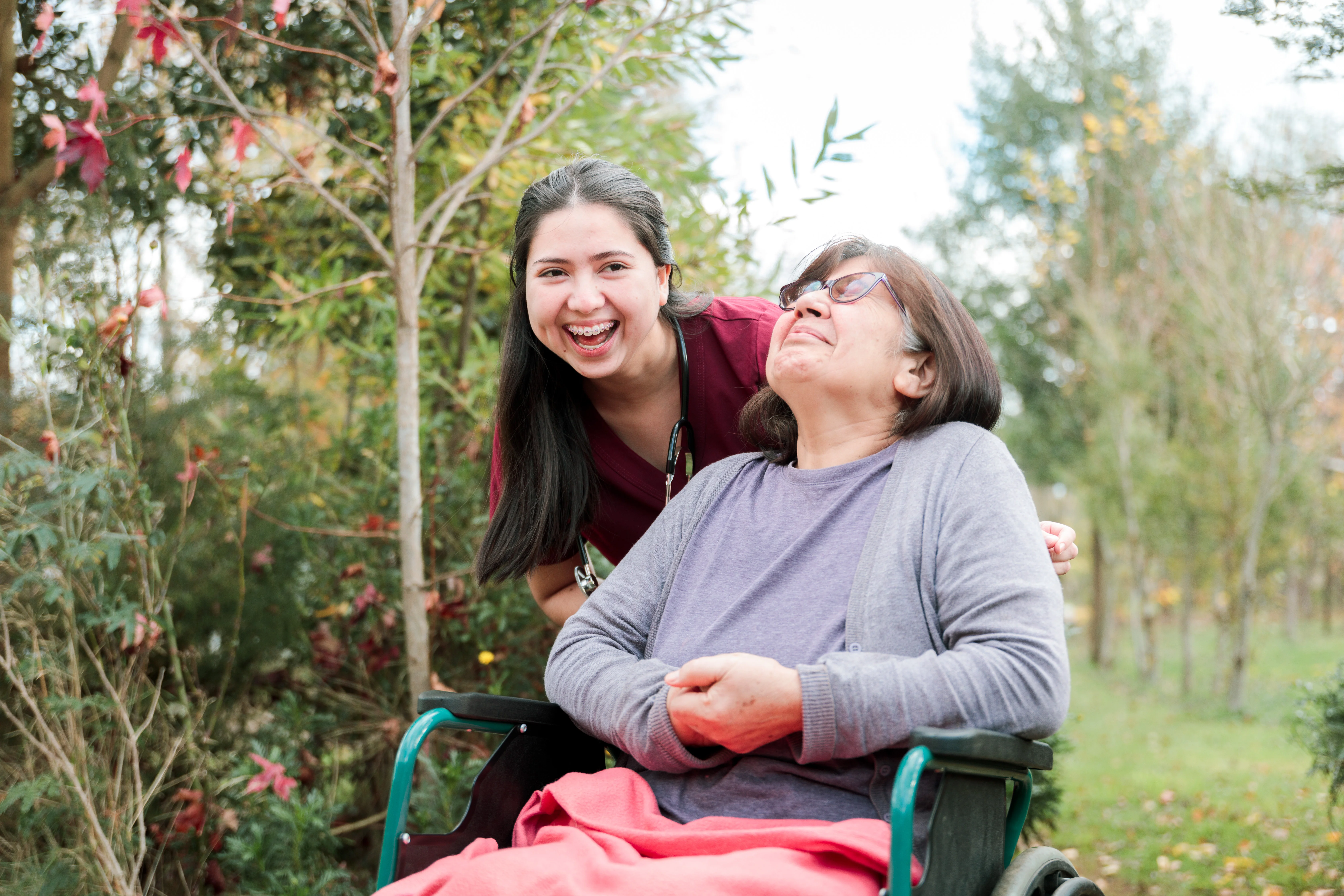 Two women laughing in the park