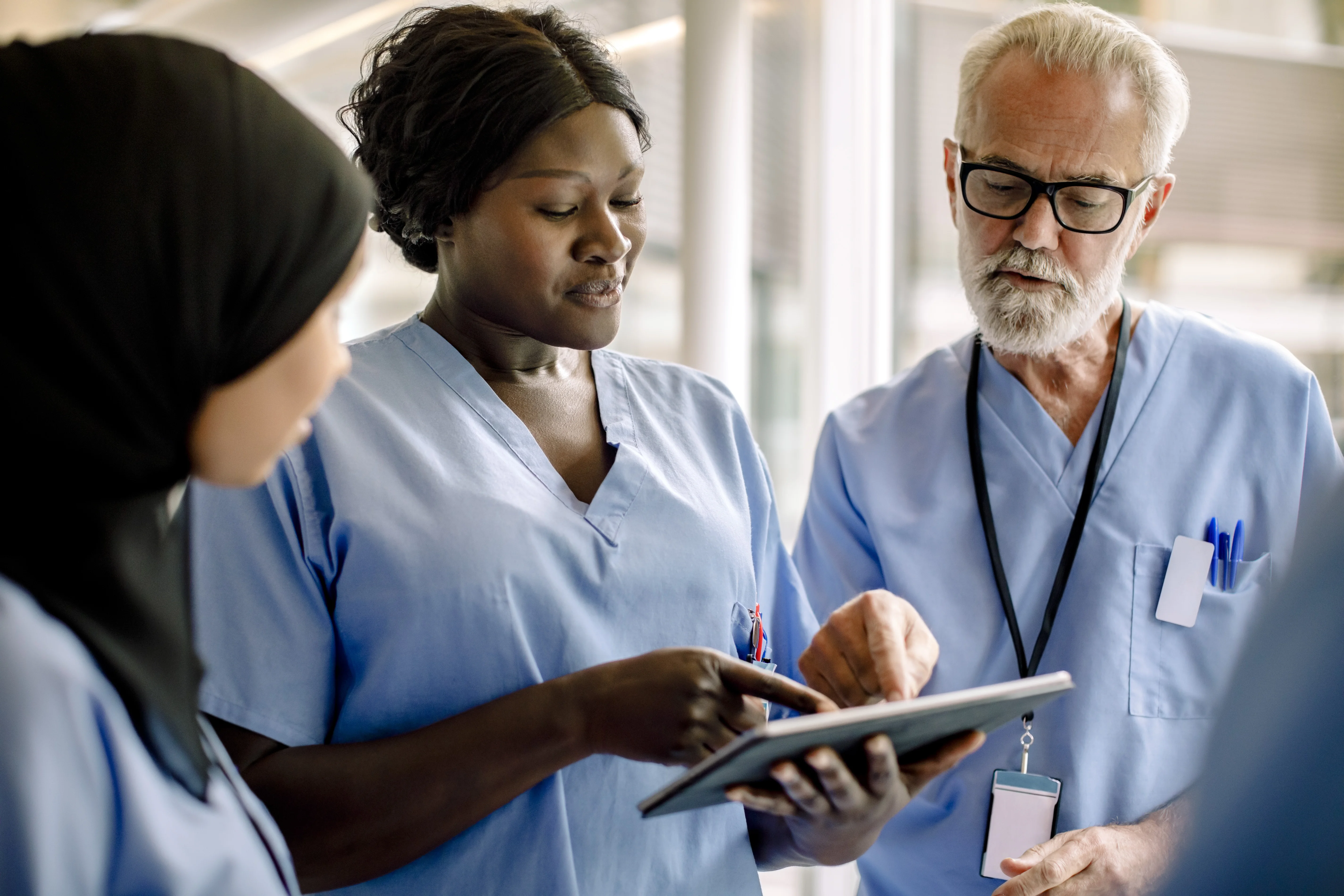a doctor showing a patient something on a tablet