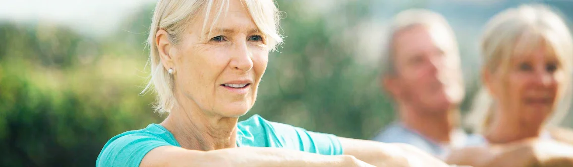 a woman smiling with people in the background