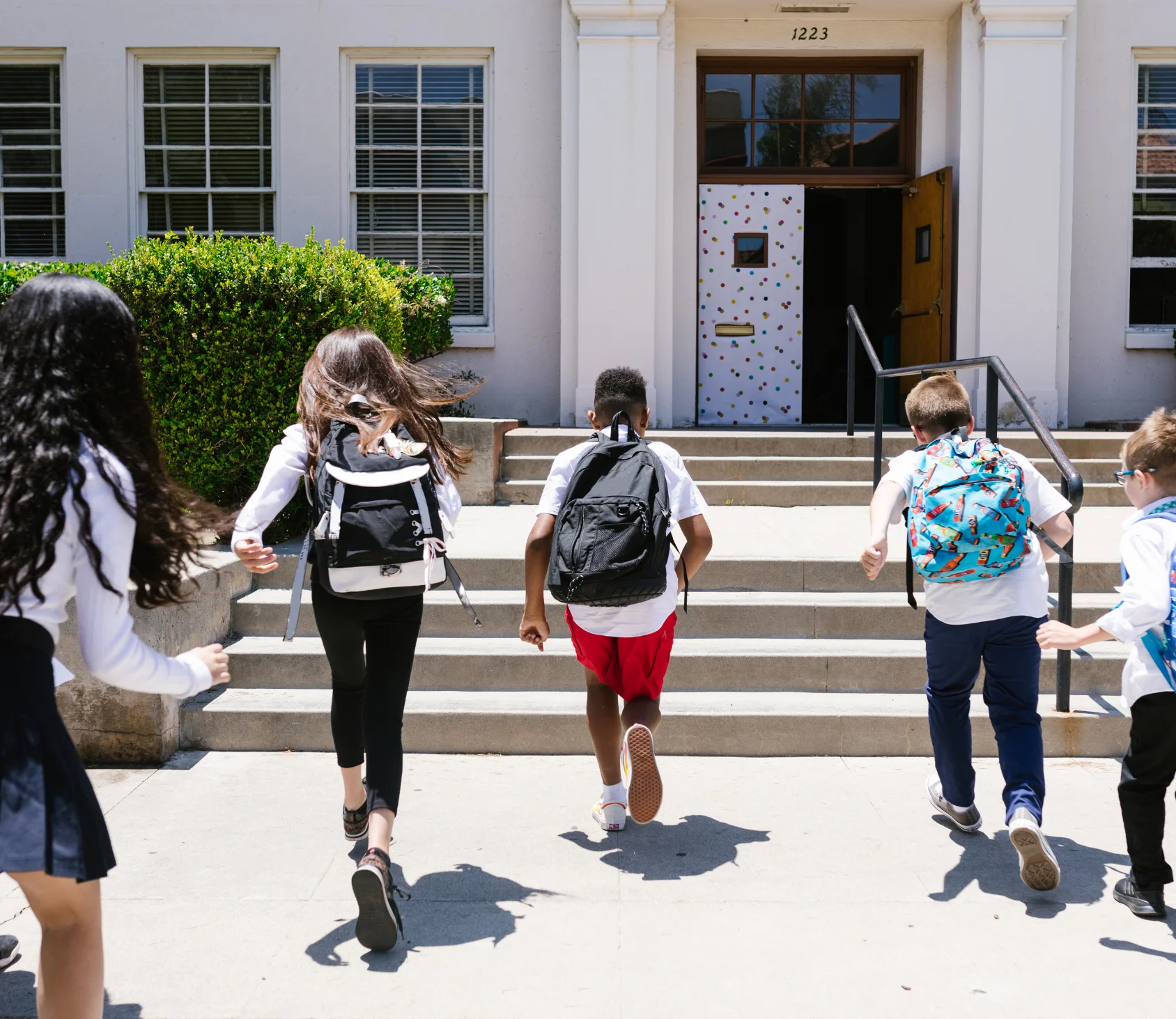 a group of people running on a sidewalk